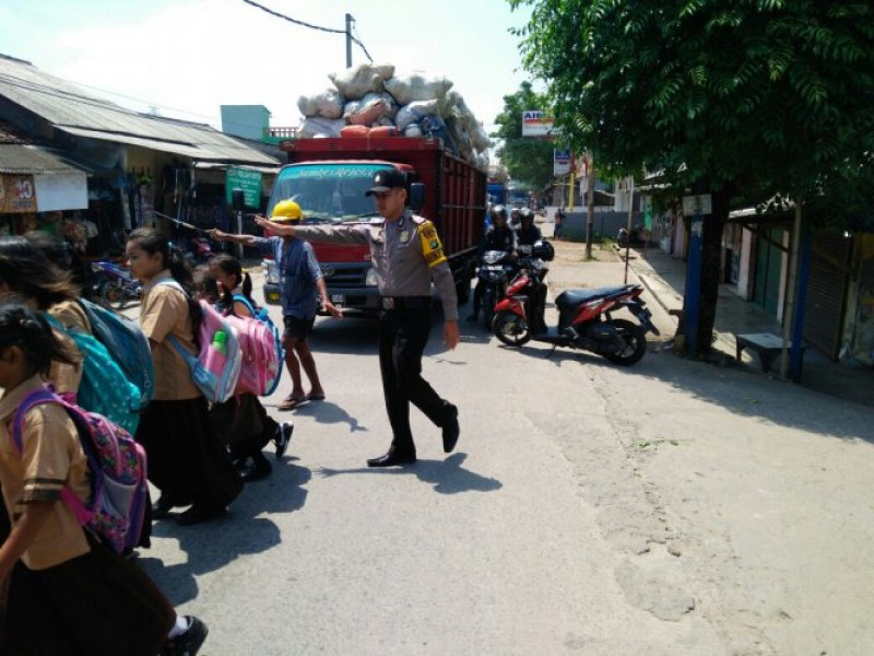 IMG-bripka-agus-noto-bantu-penyebrangan-saat-pelajar-pulang-sekolah-di-sdn-tanjung-burung